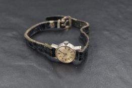 A lady's Omega wrist watch having a baton numeral dial to small silvered face in a steel case on a