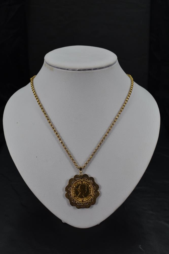 A gold sovereign dated 1968 in a 9ct gold decorative removable mount on a 9ct gold chain, approx