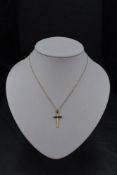 A 9ct gold cross having engine turned decoration on a fine 9ct gold rope chain, approx 16' & 1.5g