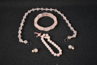 A matched set of rose quartz jewellery including earrings, necklace and two bracelets