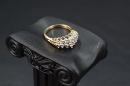 A 14 stone double row diamond ring, total approx 1ct in a claw set stepped mount on a 14ct gold
