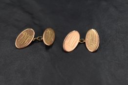 A pair of 9ct rose gold cufflinks having oval monogrammed panels and link connectors, approx 7.4g