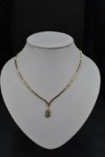 A 9ct gold necklace having three stone diamond drop, total approx 0.192ct in an open mount, with