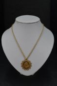 A gold sovereign Perth mint 1920 in a 9ct gold removable decorative pendant mount on a 9ct gold rope