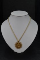 A gold sovereign Perth mint 1920 in a 9ct gold removable decorative pendant mount on a 9ct gold rope