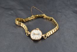 A lady's 1970's yellow metal wrist watch by Tudor having baton & Arabic numeral dial to champagne