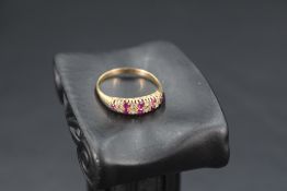 A ruby and diamond ring having a double row of alternate diamond & ruby chips in a claw set mount to