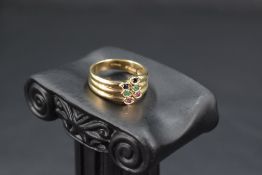 A 9ct gold triple band ring having gem set terminals, size N & approx 3.9g