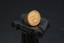 A gold sovereign coin ring, dated 1968 held within a geometrically cut bezel mount in a textured