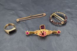 Four pieces of damaged yellow metal jewellery including garnet brooch, 9ct gold signet ring with