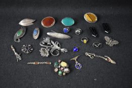 A selection of silver and white metal jewellery including polished stone brooches, large marcasite