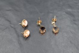 Two pairs of yellow metal earrings including smoky quartz and cameo