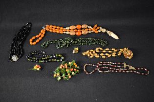 A small selection of strings of beads including Amber style, mourning, 1950's moulded glass etc