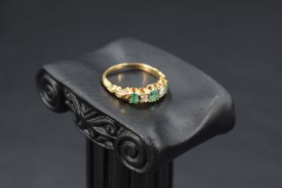 A Victorian diamond and emerald five stone ring having three baguette cut emeralds and two old cut