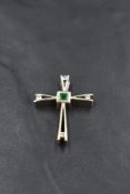 An artisan made cross pendant (no chain) having a central emerald with inset diamond detail to