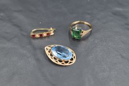 Three pieces of yellow metal jewellery, including pendant with oval blue paste stone, odd earring