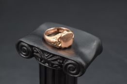 A gent's 9ct rose gold signet ring having plain shield panel and moulded shoulders, size S &