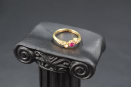 An Edwardian seed pearl and ruby ring having central ruby with pearl set crossover shoulders, on