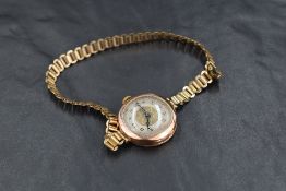 A lady's vintage 9ct rose gold wrist watch having Arabic numeral dial to decorative face in rose