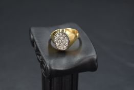 A gent's yellow metal signet ring having an oval panel set with 16 small diamonds total approx 0.