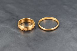 Two 22ct gold wedding bands, smaller one having engraved floral decoration, sizes G & T, approx 7g
