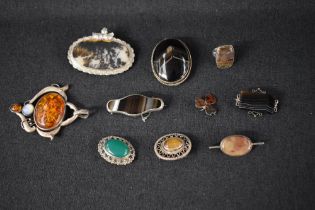 Ten pieces of silver and white metal jewellery all having polished stones, including oversized