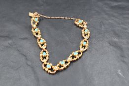 A Victorian 15ct gold bracelet having open links with turquoise and seed pearl decoration and