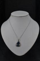 A black opal doublet pendant of naturalistic form on an 18ct white gold chain, approx 16' & 7.1g