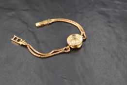 A lady's 1950's 18ct gold Omega cocktail watch having dot numeral dial to small circular face within