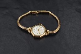 A ladies vintage 9ct gold wrist watch by Vertex having Arabic numeral dial and subsidiary seconds on