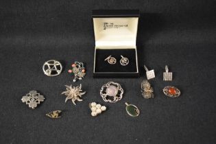 A small selection of silver and white metal jewellery including several brooches, pendants and two