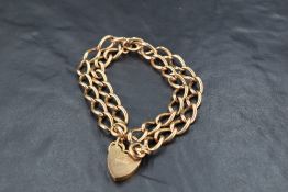 A 9ct gold double link bracelet with padlock clasp, approx 8' & 35g