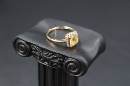 A facet cut citrine ring having a diamond halo surround, total approx 0.12ct in a basket style mount