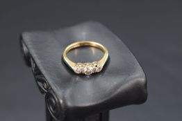 A diamond trilogy ring, approx 0.5ct total in a claw set mount on an 18ct gold loop, size L & approx