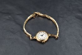 A lady's 9ct gold wrist watch by Rotary having an Arabic numeral dial to cream face in plain
