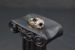 A sapphire and diamond cluster ring, approx 0.5ct diamonds & 0.5ct sapphire, all in a claw set