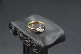 A diamond trilogy ring, approx 0.195ct total to twist shoulders to yellow metal loop, marks worn,