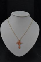 A coral and diamond set cross pendant in an 18ct gold mount on a fine 18ct gold chain, approx