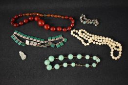 Six pieces of costume jewellery including cherry amber style graduated beads, two pieces of