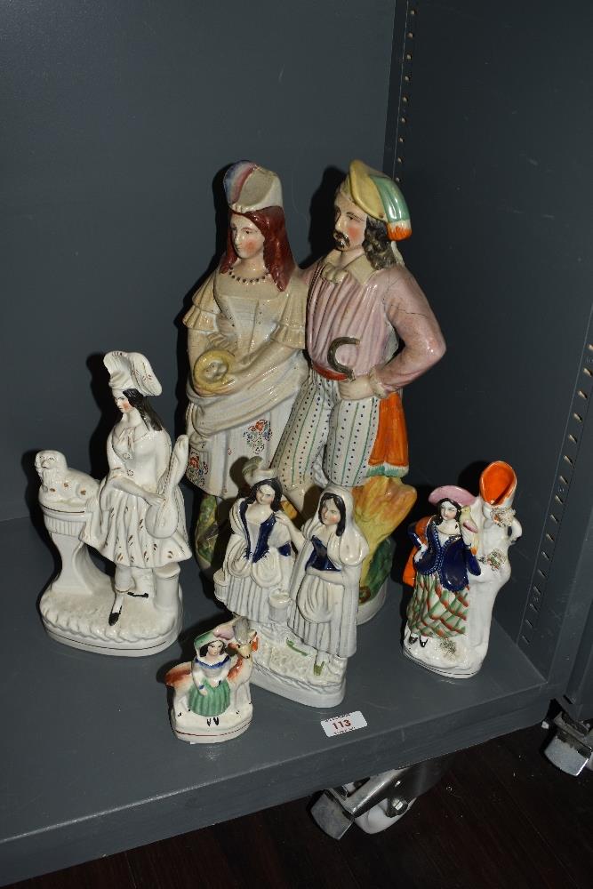 A group of 19th Century Staffordshire flatback ornaments, to include a large courting couple