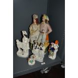 A group of 19th Century Staffordshire flatback ornaments, to include a large courting couple