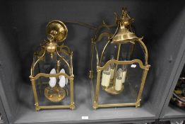 A pair of 20th Century four sided glass and brass framed lantern light fittings, each measuring 50cm