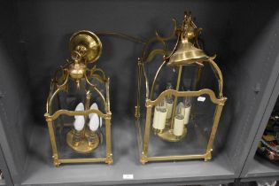 A pair of 20th Century four sided glass and brass framed lantern light fittings, each measuring 50cm