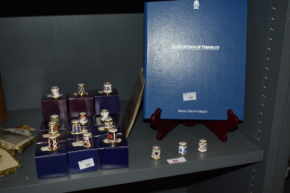 A collection of Royal Crown Derby porcelain collector's thimbles, with boxes, and informative guide