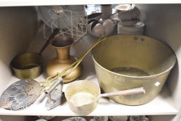 A large brass jam pan, two brass saucepans, a flat iron and similar.