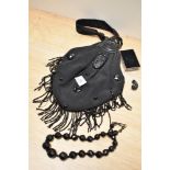A late Victorian handbag, having moulded vulcanite handle and faceted beaded necklace.
