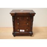 A Victorian mahogany tobacco box, with interior tin lining, modelled as a Scotch chest of drawers,