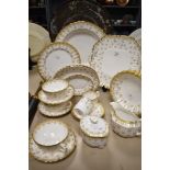 A selection of Spode 'Fleur de Lys Gold', comprising; deep large dish, plates, bowls, jug, sugar,