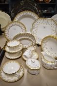 A selection of Spode 'Fleur de Lys Gold', comprising; deep large dish, plates, bowls, jug, sugar,
