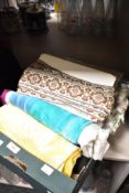 A selection of fabrics, including silk and vintage braiding and edging tapes.